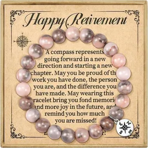 Retirement gift bracelet with natural pink stone beads and compass pendant in gift box