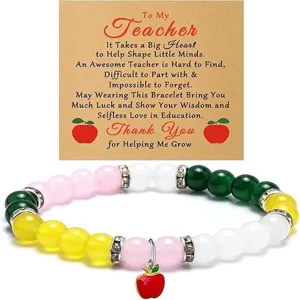 Detailed view of teacher appreciation beaded bracelet with cute red apple charm and message card.