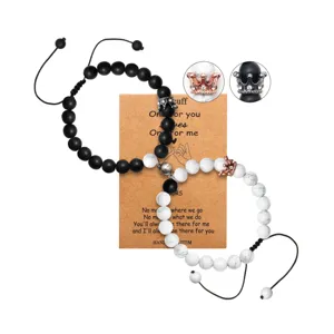 Couple magnetic bead bracelets set with crown charms, matching black and white stone distance bracelets.
