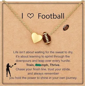 Gold football necklace detail showing heart and sports ball pendants on display card.