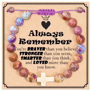Detailed view of handmade imperial jasper beaded bracelet with adjustable cord and cross charm.