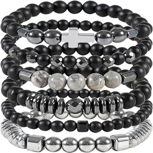 Detail shot of multi-layer beaded stack bracelet with cross charm and hematite stones.