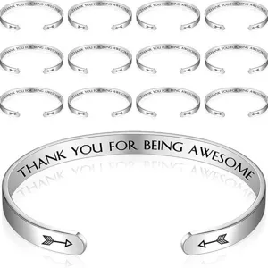 Close-up detail view of stainless steel inspirational engraved cuff bracelet texture.