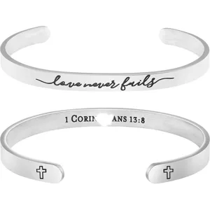 Stainless steel C-shaped cuff bracelet detail featuring inspirational engraved text.