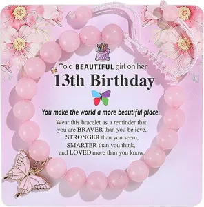 Pink beaded bracelet detail view showcasing butterfly charm and nice birthday greeting card.