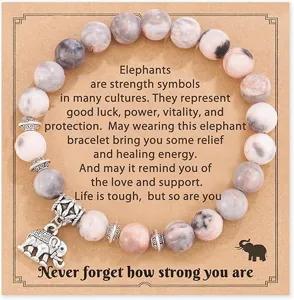 Detail shot of natural stone beaded bracelet with cute elephant charm and inspiring card.