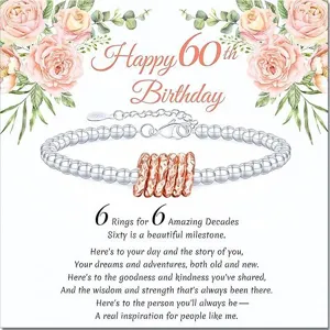 Detailed view of the 60th birthday silver bead bracelet with rose gold rings on card.