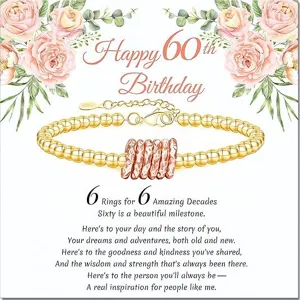 Detailed view of the elegant 60th birthday gold bead bracelet with message card.