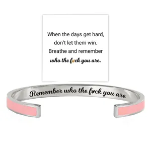 Stainless steel cuff bracelet with pink enamel detail and inspiring engraved quote.