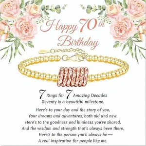 Gold beaded bracelet with seven rings for 70th birthday gift, adjustable chain detail.