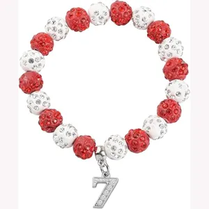 Close-up detail of red and white rhinestone beaded sports bracelet with number 7 charm.