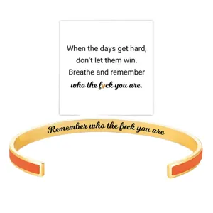 Stainless steel open cuff bracelet with motivational quote engraving and colorful enamel details.