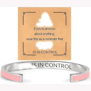Stainless steel open cuff bracelet with pink enamel and motivational engraved text for daily wear.