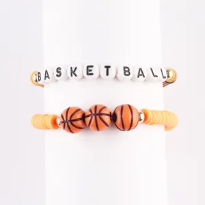 Detailed view of handmade sports stacked beaded bracelets featuring basketball designs and letter beads.