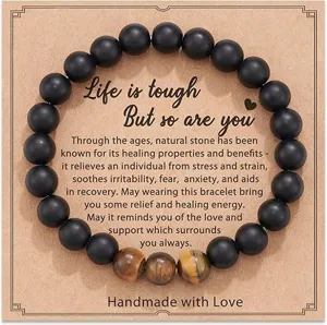 Natural stone beaded bracelet with motivational card, black matte and tiger eye beads detail.