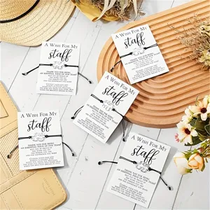 Staff wish card bracelet set featuring black woven cord and metal puzzle pendant design.