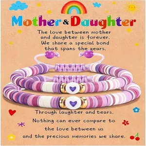Close up of colorful beaded mother and daughter bracelets featuring sweet heart charms and cord.