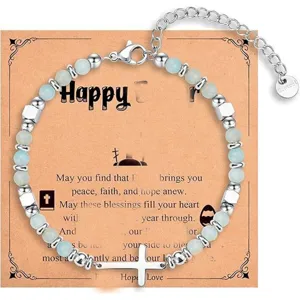 Natural stone beaded cross bracelet with stainless steel components and blessing card.