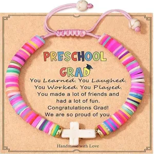 Colorful heishi bead preschool graduation bracelet with white cross pendant and pink cord.