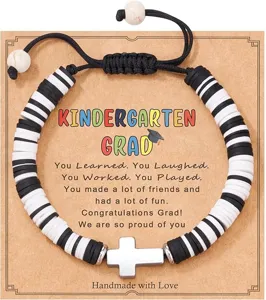 Detailed shot of graduation heishi bead bracelet with cross pendant and congratulatory card.