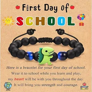 Children black beaded bracelet with cute green dinosaur charm and blue cat eye beads detail