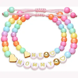 Matching Mommy and Me beaded bracelets set with colorful pastel pearls and sweet gold heart charms