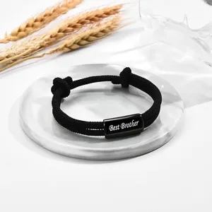 Detailed view of the black braided rope adjustable bracelet with engraved metal bar gift.