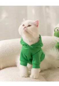 Detailed view of cute green fleece pet hoodie for cats and small dogs, autumn winter wear.