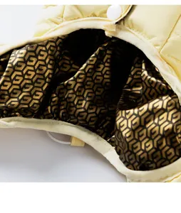Pet down jacket detail shot featuring warm yellow outer fabric and luxury style monogram lining.