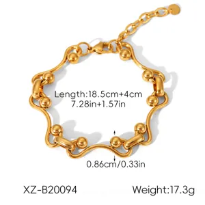 Gold stainless steel wavy link bracelet detail view, elegant ball charm and adjustable size.