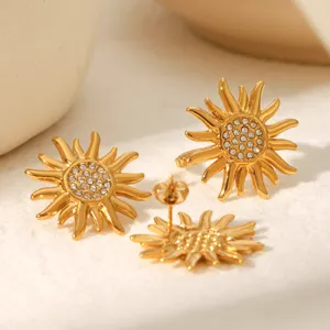 Detailed view of golden stainless steel sun rhinestone earrings and ring jewelry set.