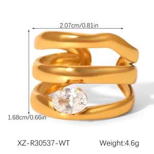 Detailed close-up of the multi-layer wavy 18k gold plated ring with oval zirconia stone.