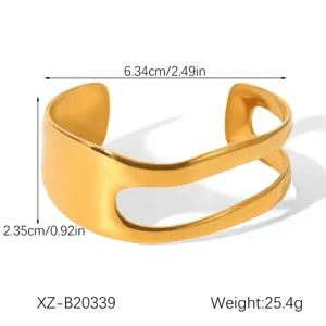 Detailed view of wide open cuff bracelet, minimalist gold metal design with size specs.