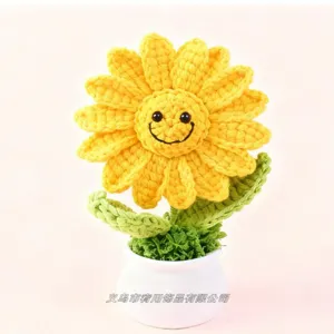 Close-up detail of handmade crochet sunflower potted plant, cute desktop decor gift.