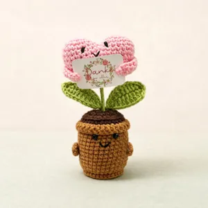 Handmade crochet potted plant detail, cute knitted pink flower doll ornament decoration.