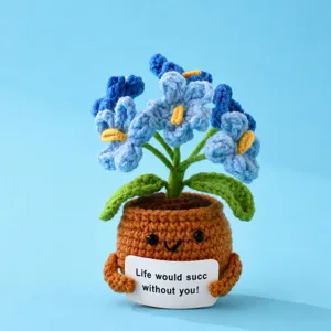 Handcrafted crochet potted plant doll with cute smiling face and blue flowers detail.
