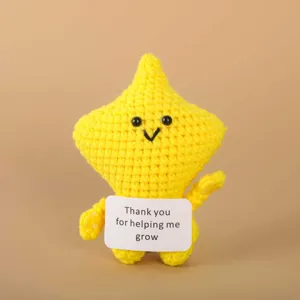 Handmade crochet yellow star plush doll detail view with cute smiling face and thank you card.