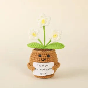 Handmade crochet potted plant toy with cute face and encouraging message card for home decor.