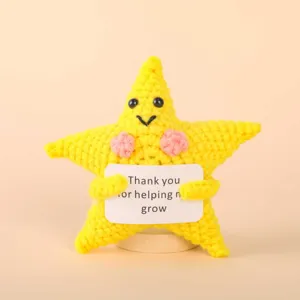 Detailed view of the handmade crochet star plush toy with a cute thank you sign and base.