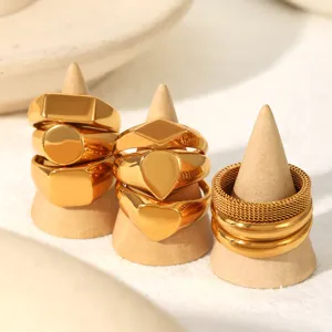 Gold stainless steel stackable ring set detail view showing geometric and mesh designs