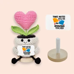 Detailed view of handmade crochet heart potted plant with teacher greeting card and wood base.