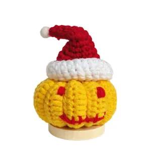 Handmade crochet Halloween pumpkin doll with Santa hat, cute wool desktop ornament gift.