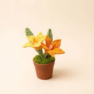 Close-up detail of handmade crochet lily flower potted plant ornament for desk decor.