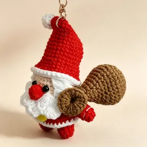 Handmade crochet Santa Claus keychain cute yarn plush doll pendant festive gift bag charm.