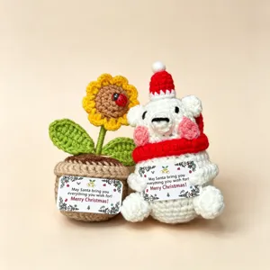 Handmade crochet Christmas polar bear and sunflower potted plant, detailed holiday gift display.