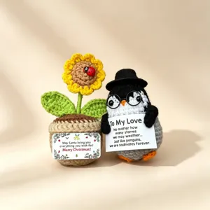 Handmade crochet penguin doll and sunflower potted plant, detailed handmade holiday gift decor.