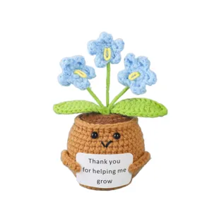Handmade crochet potted plant doll with cute face and blue flowers, emotional gift.