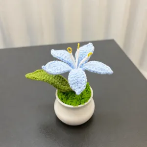 Handmade crochet blue lily flower potted ornament detail, beautiful desktop or car decoration.