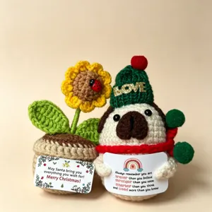 Handmade crochet Christmas penguin and sunflower potted plant detail view, festive plush toy.
