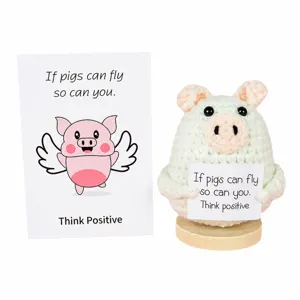 Cute crochet flying pig doll with wooden base and encouraging quote card for creative desktop gift.